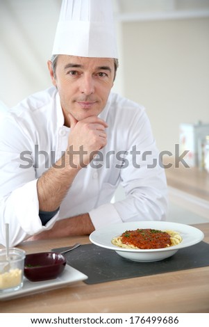 Portrait of chef in kitchen preparing italian dish