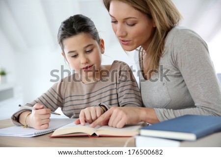 Mom helping kid with homework