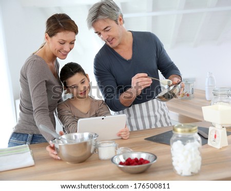Family in home kitchen preparing pastry
