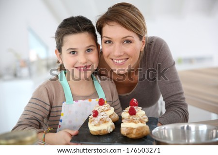 Mother and daughter preparing cream puffs