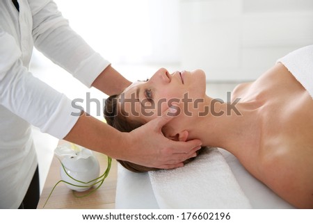 Woman having a face massage in beauty institute