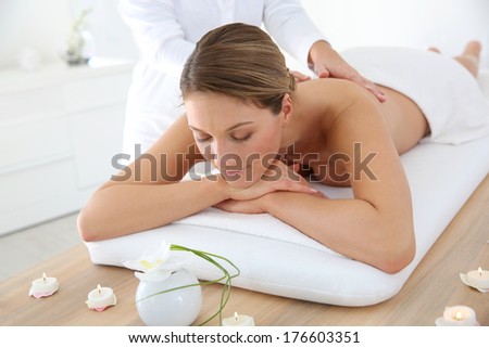 Woman in spa institute receiving oil massage