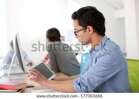 Student in class using digital tablet