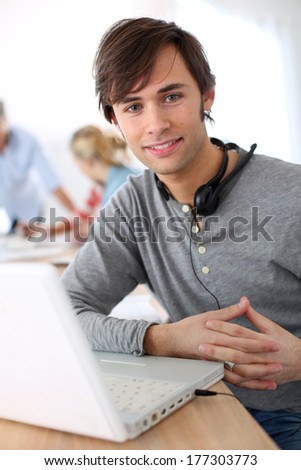 Student with headset on doing English language test