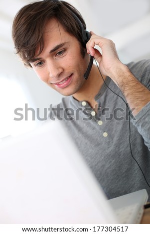 Student with headset on doing English language test