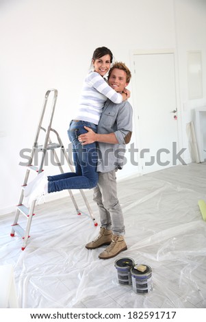 Young man holding girlfriend in arms