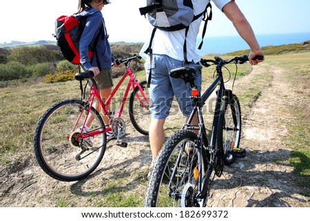 Couple walking in countrypath with bikes