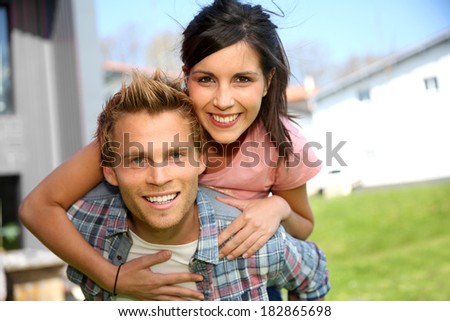 Young man giving piggyback ride to girlfriend