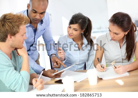 Young business people meeting around table