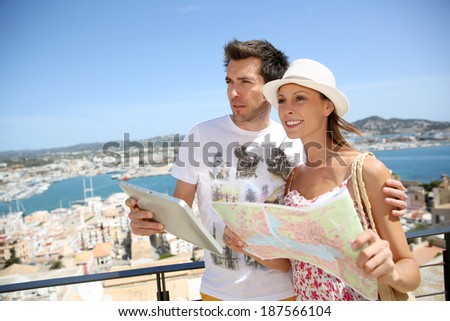 Couple of tourists reading map at the top of Ibiza old town