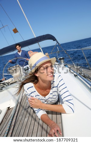 Beautiful woman with hat enjoying cruising on boat