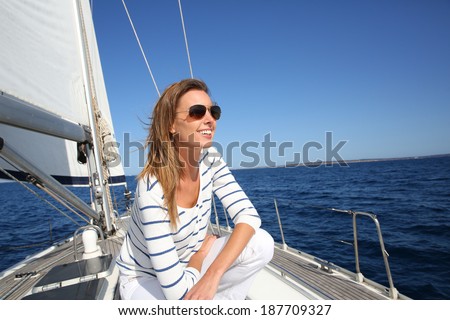 Attractive modern woman enjoying sailing cruise