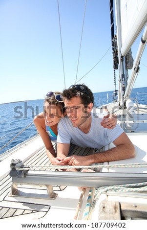 Couple relaxing on sailboat deck