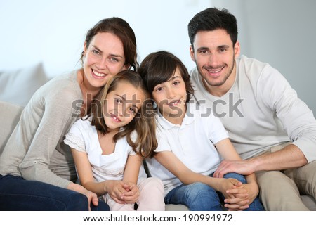 Happy family sitting together in couch