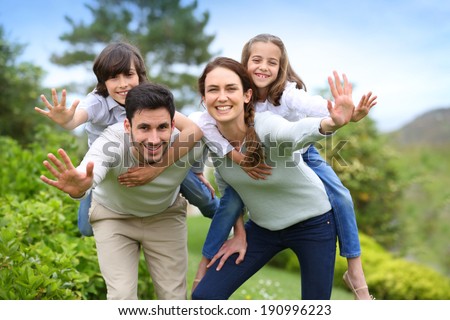 Happy family having fun in home garden