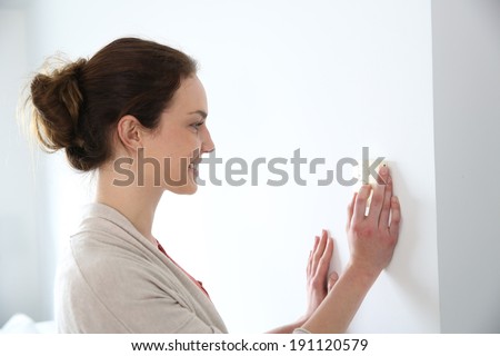Woman programming temperature inside home