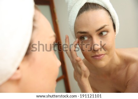 Woman in bathroom looking in mirror