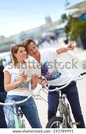 Couple reading map on bike tour