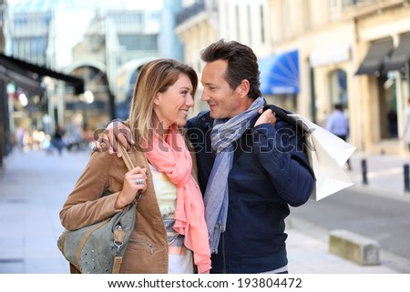 Middle-aged couple doing shopping on week-end