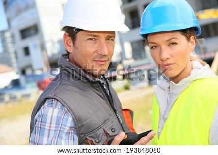 Construction partners standing on building site