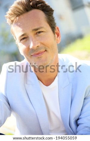 Handsome 40-year-old man relaxing in park