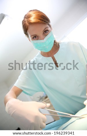 Surgeon woman with mask in surgery room