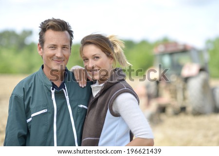 Couple of farmers standing in farming land