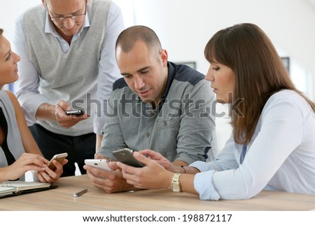 Business group meeting with smartphones