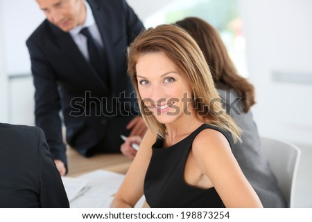 Smiling attractive businesswoman attending meeting