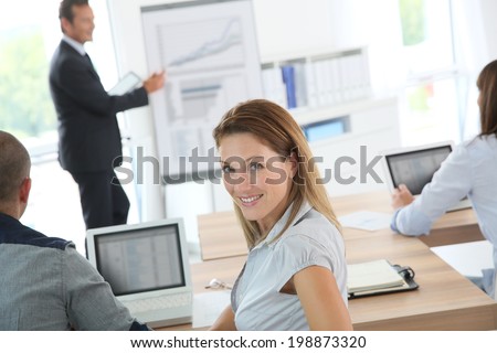Portrait of smiling woman attending business presentation