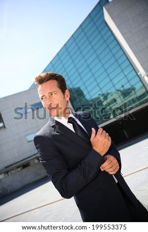 Businessman waiting for meeting outside building