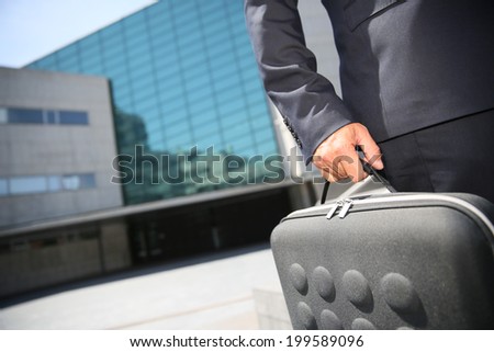Closeup of briefcase held by businessman