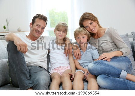 Happy family relaxing on couch at home
