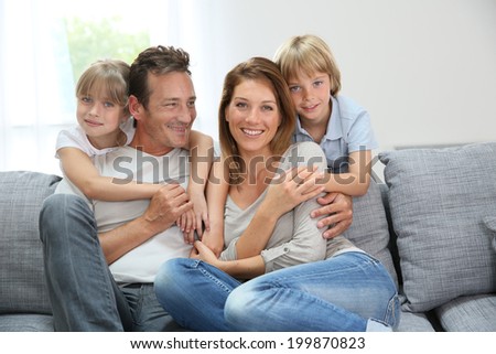 Happy family relaxing on couch at home