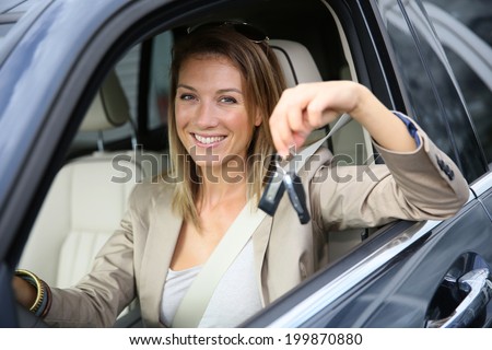 Smiling attractive woman holding brand new car keys