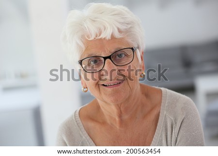 Portrait of smiling elderly woman with eyeglasses