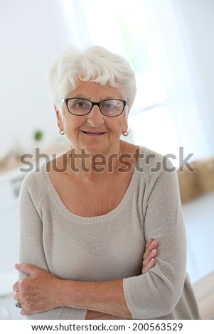 Portrait of smiling elderly woman with eyeglasses