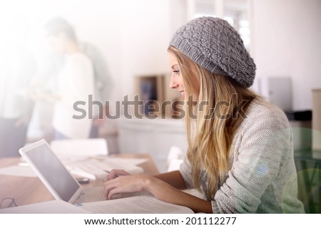 Portrait of student girl working on laptop
