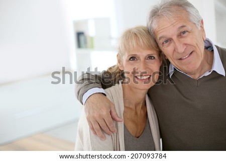 Cheerful senior couple embracing each other