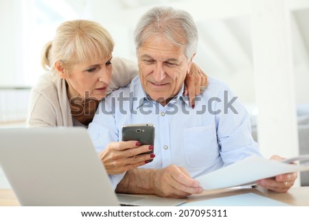 Senior couple doing the income tax declaration online