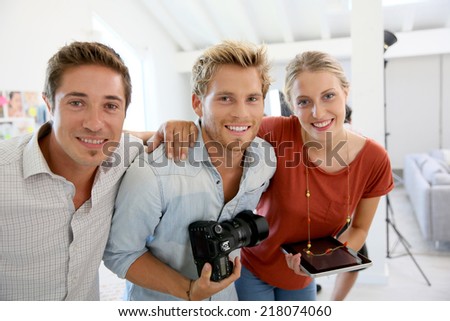 Portrait of cheerful creative team in photo agency