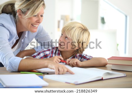 Mom helping little boy to do homework