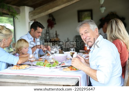 Family having summmer lunch in country house