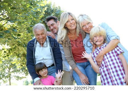 Happy 3 generation family in grandparents\' backyard