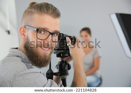 Portrait of young photographer working in studio