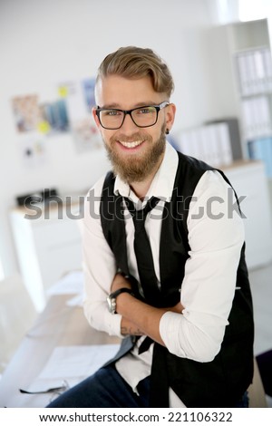 Young man with beard and eyeglasses in office