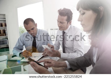 Business people checking on smartphone to book meeting time