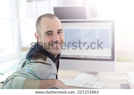 Portrait of student in front of desktop computer