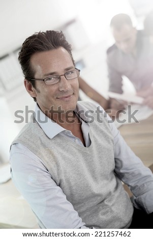 Mature businessman attending work meeting