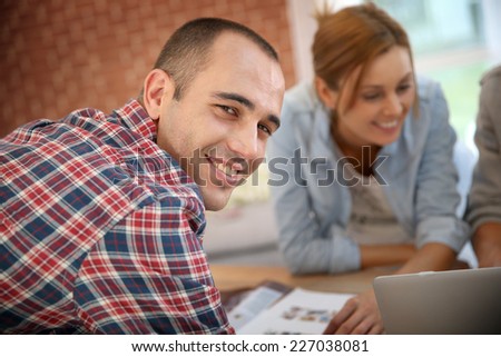 Smiling guy in shared apartment with roommates